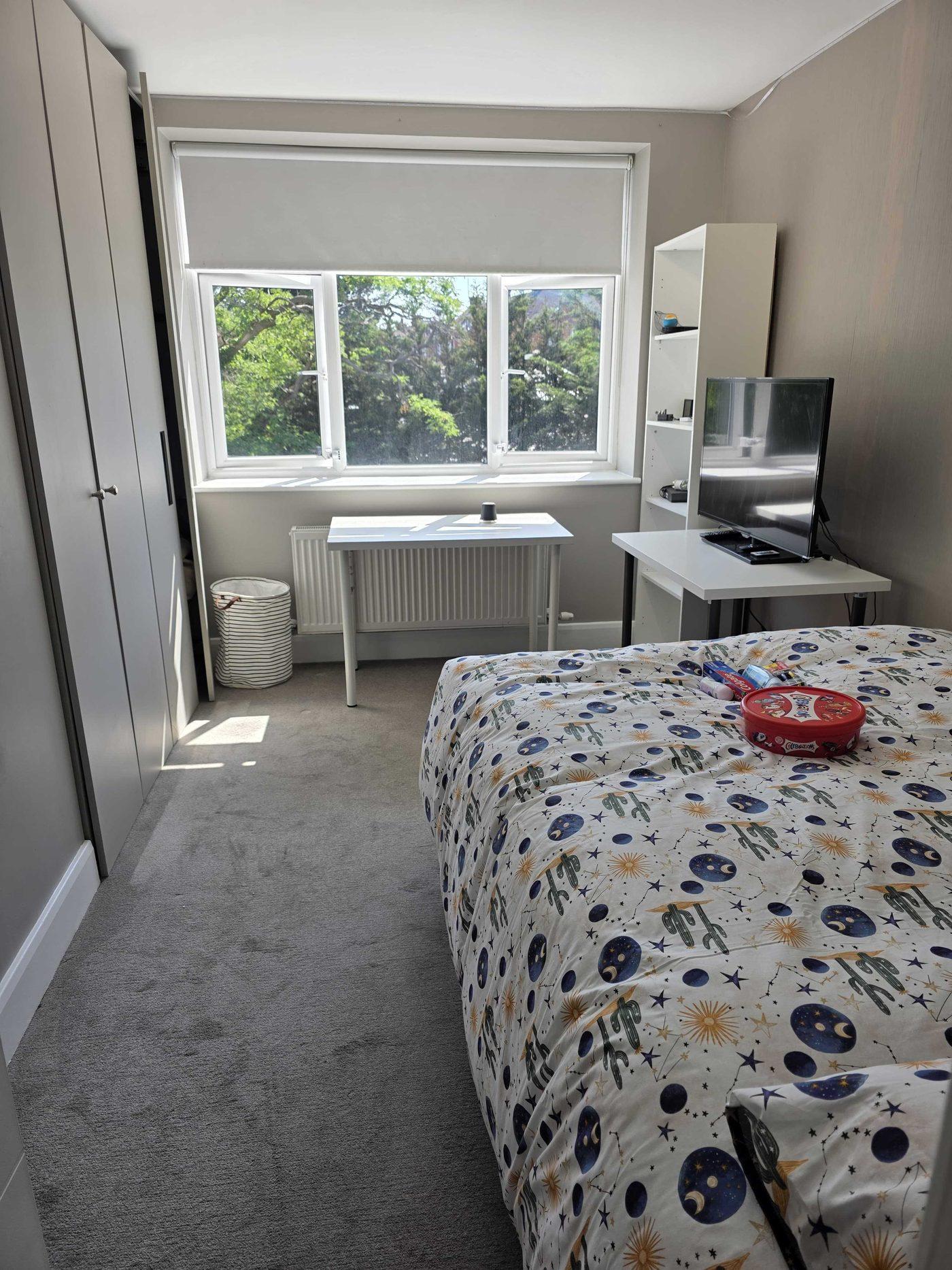 Bright bedroom with study desk at Shapes
