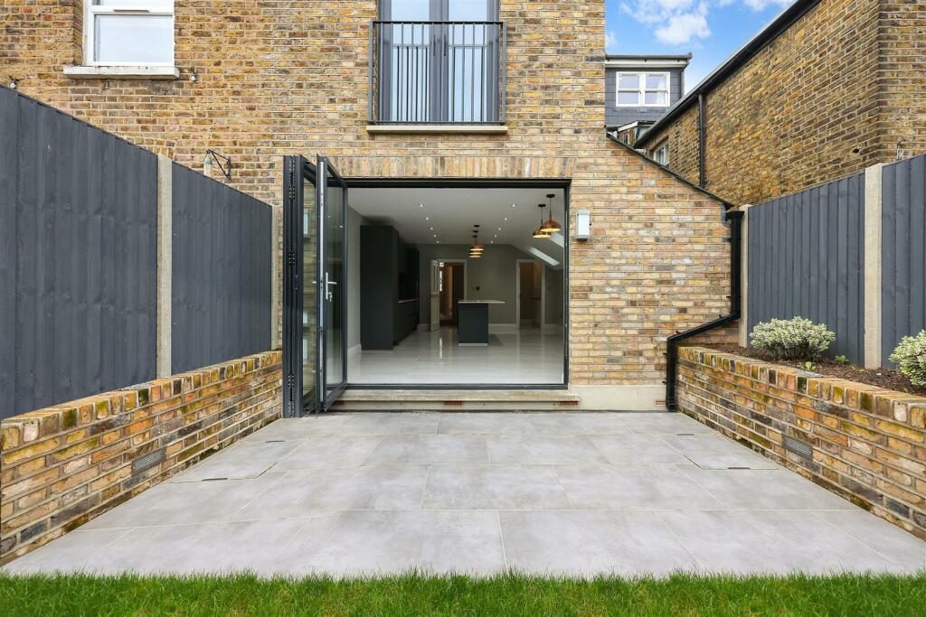 Landscaped patio garden with bi-fold doors at Turtle Green