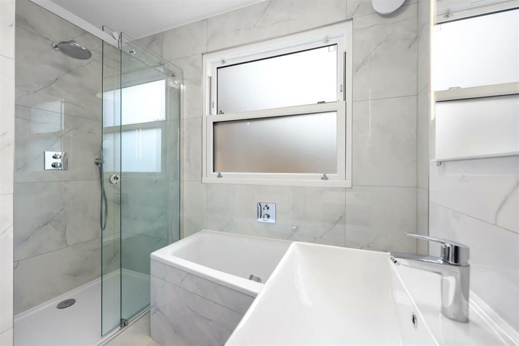Modern bathroom with shower and bath at Turtle Green